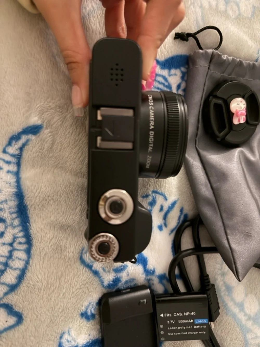 Black Compact Digital Camera with Lens Cap and Charger